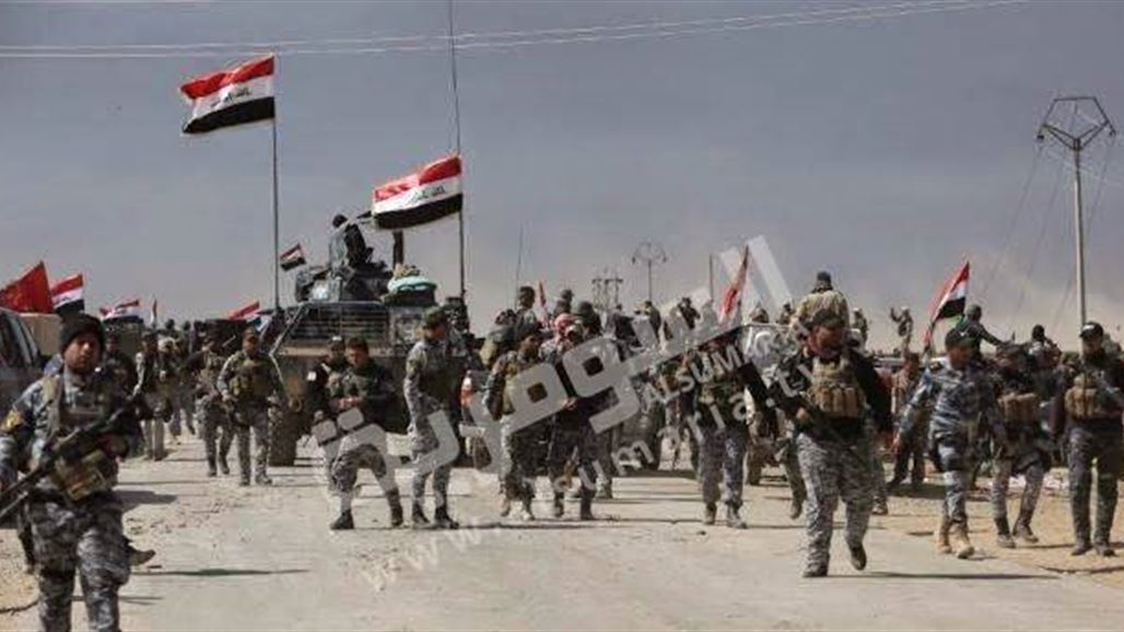 القوات الأمنية ترفع العلم العراقي على خط اللاين غرب سامراء