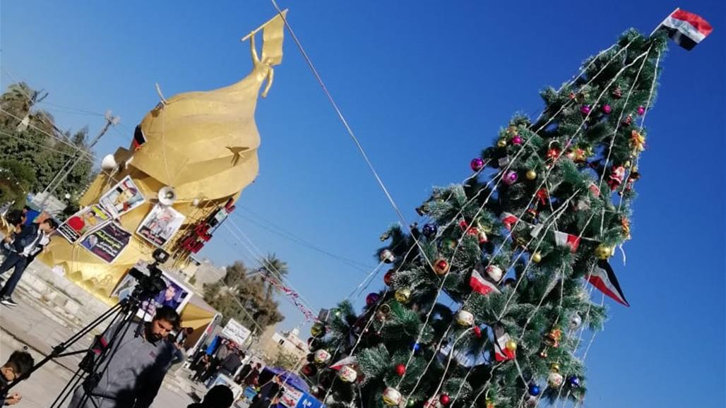 In pictures .. A tree like Christmas in the demonstration square in Karbala