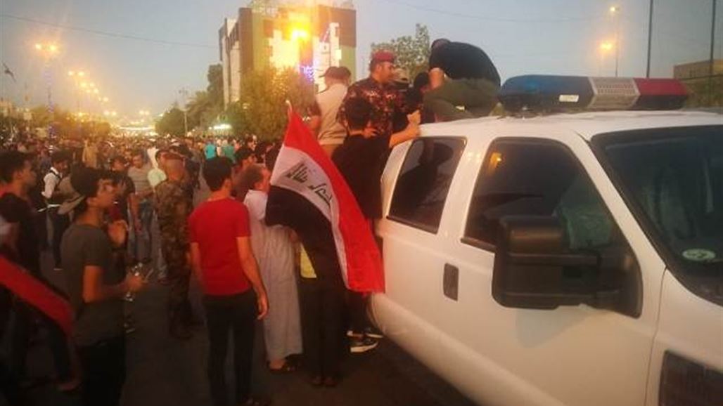 القوات الامنية توزع الماء على المتظاهرين في كربلاء